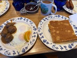 Al Johnson’s Swedish Restaurant signature dishes Swedish Pancakes with Lingonberries, Swedish Meatballs, Pytt i Panna (Swedish Hash), Pickled Herring